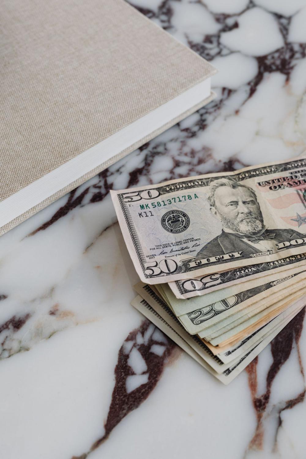 Dollar bills on a marble table Dollar bills on a marble table