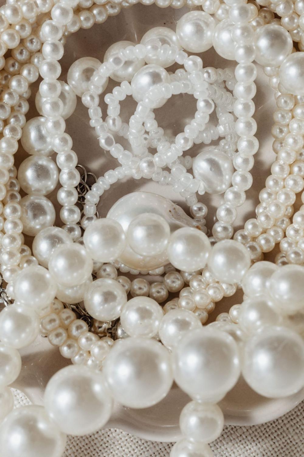 Pearl jewelry - backgrounds - flatlays - from above Pearl jewelry - backgrounds - flatlays - from above
