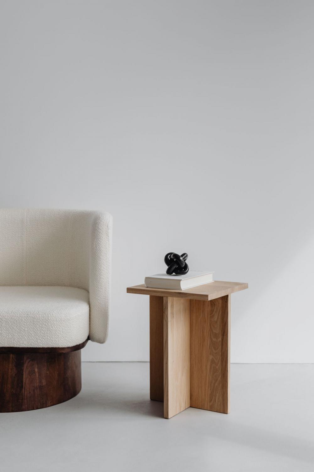 Modern oak side table - armchair with light boucle fabric - minimalist interior Modern oak side table - armchair with light boucle fabric - minimalist interior