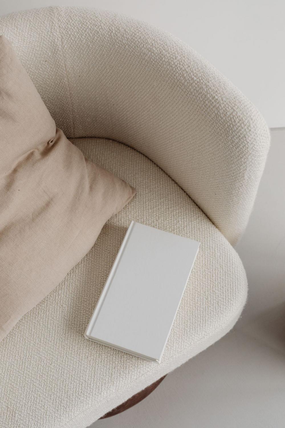 Free photos for mockups - blank cover book - cream armchair - linen pillow Free photos for mockups - blank cover book - cream armchair - linen pillow