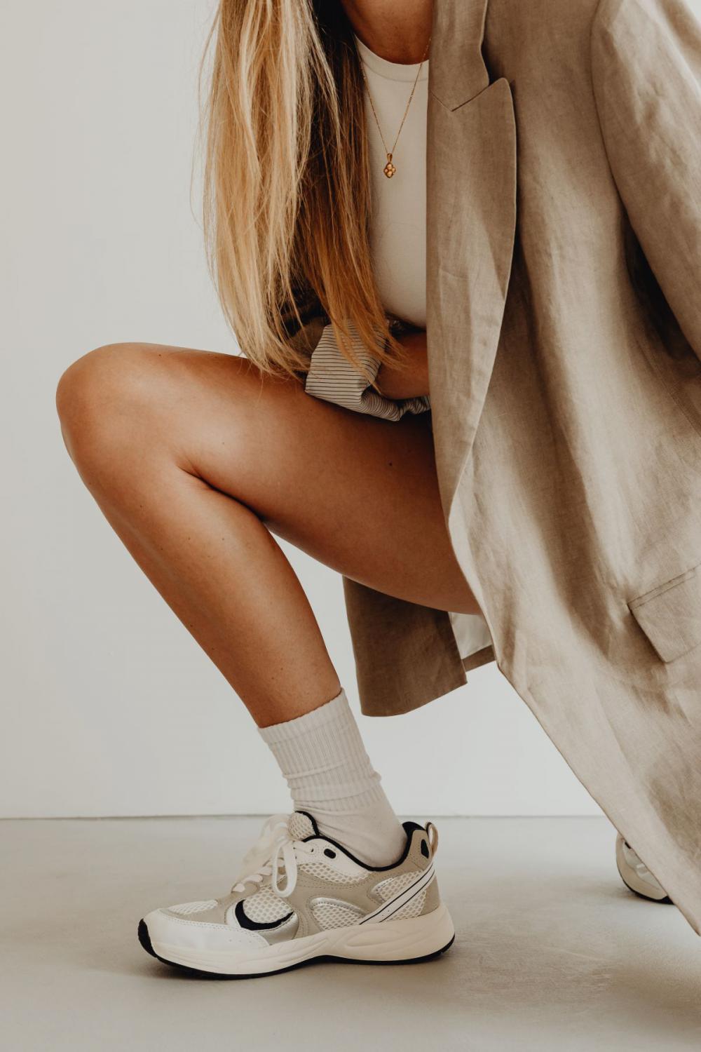 Woman wearing white elegant shorts and linen oversize jacket Woman wearing white elegant shorts and linen oversize jacket