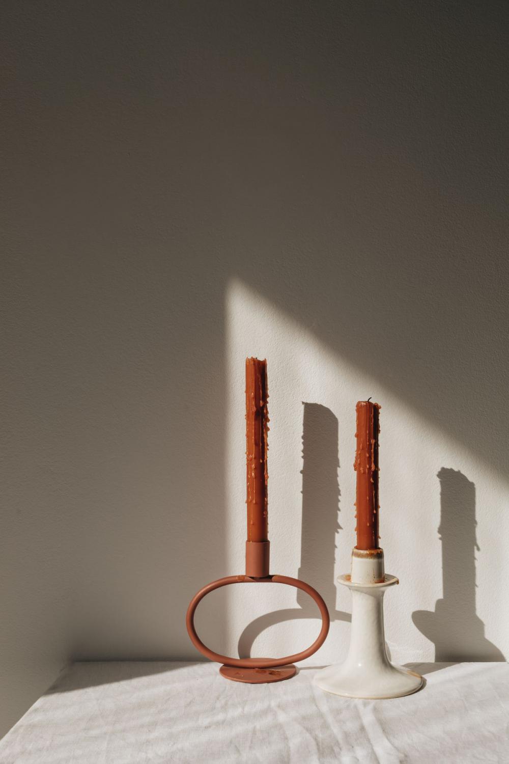 Orange-colored candles on the background of the painting Orange-colored candles on the background of the painting
