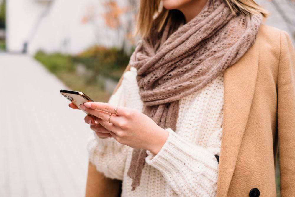 Female holding her phone on an autumn day closeup 3 Female holding her phone on an autumn day closeup 3