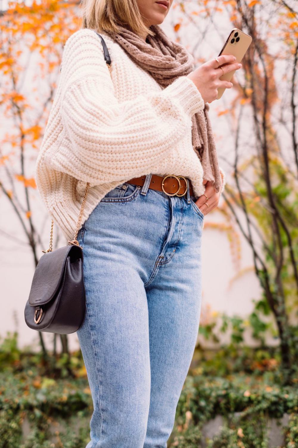 Female holding her phone on an autumn day 2 Female holding her phone on an autumn day 2