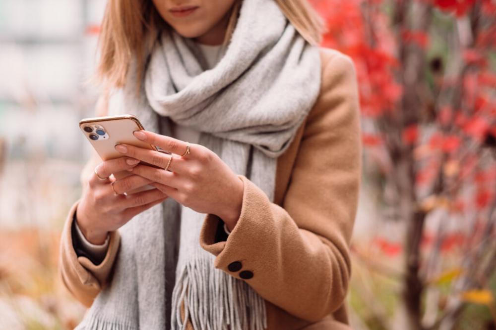 Female holding her phone on an autumn day closeup 6 Female holding her phone on an autumn day closeup 6