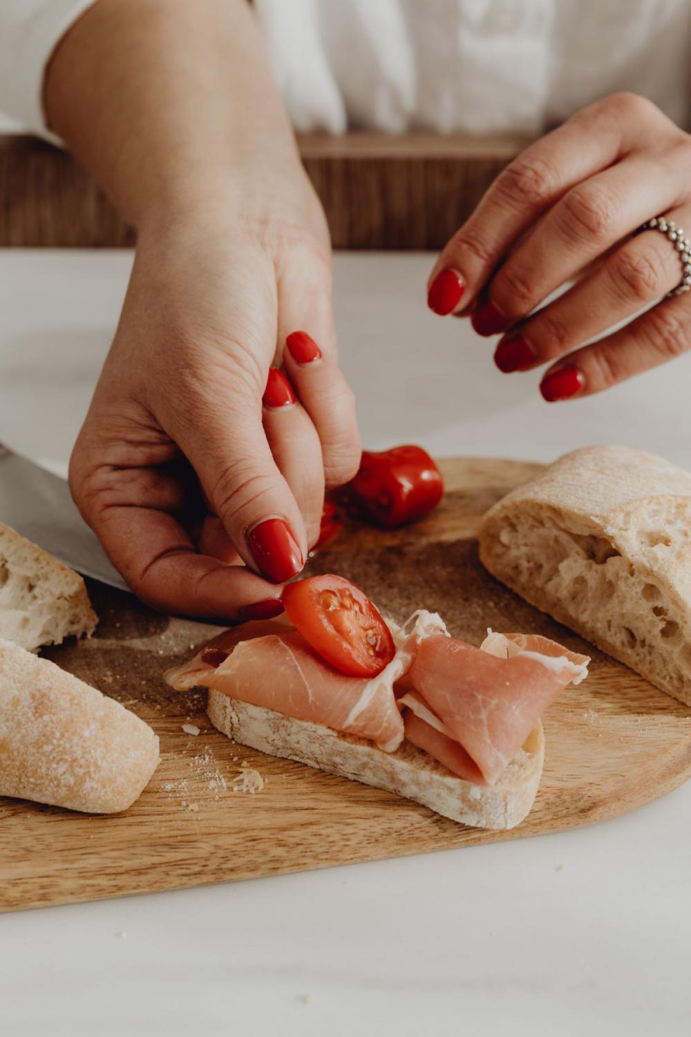 Woman making bruschetta with healthy ingredients Woman making bruschetta with healthy ingredients