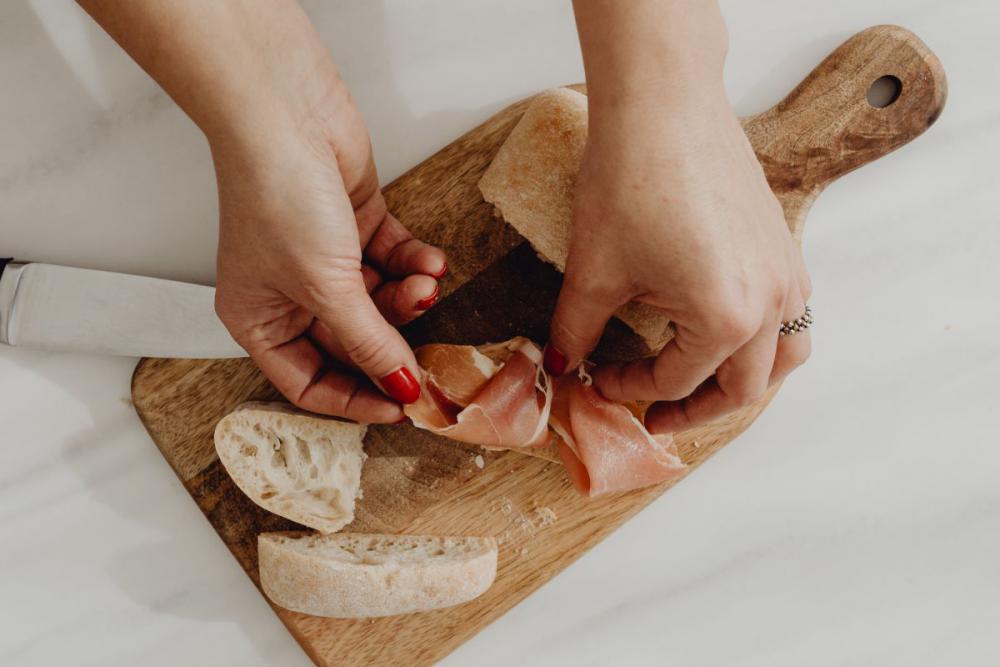 Woman making bruschetta with healthy ingredients Woman making bruschetta with healthy ingredients