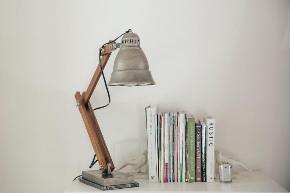 Silver Lamp On A White Table Next To Books Photo Silver Lamp On A White Table Next To Books Photo