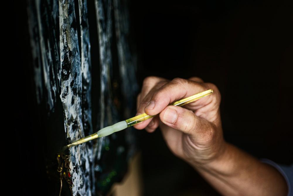 Hand Holds A Yellow Paint Brush To A Painting Of Trees Photo Hand Holds A Yellow Paint Brush To A Painting Of Trees Photo