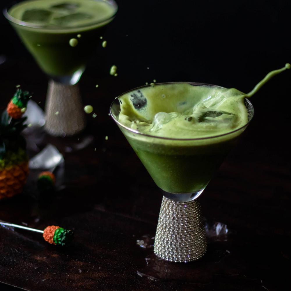 Foamy Green Drink Splashes In Cocktail Glass Photo Foamy Green Drink Splashes In Cocktail Glass Photo