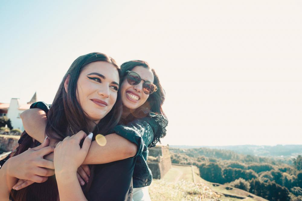 Woman Hugs Other Woman From Behind Photo Woman Hugs Other Woman From Behind Photo