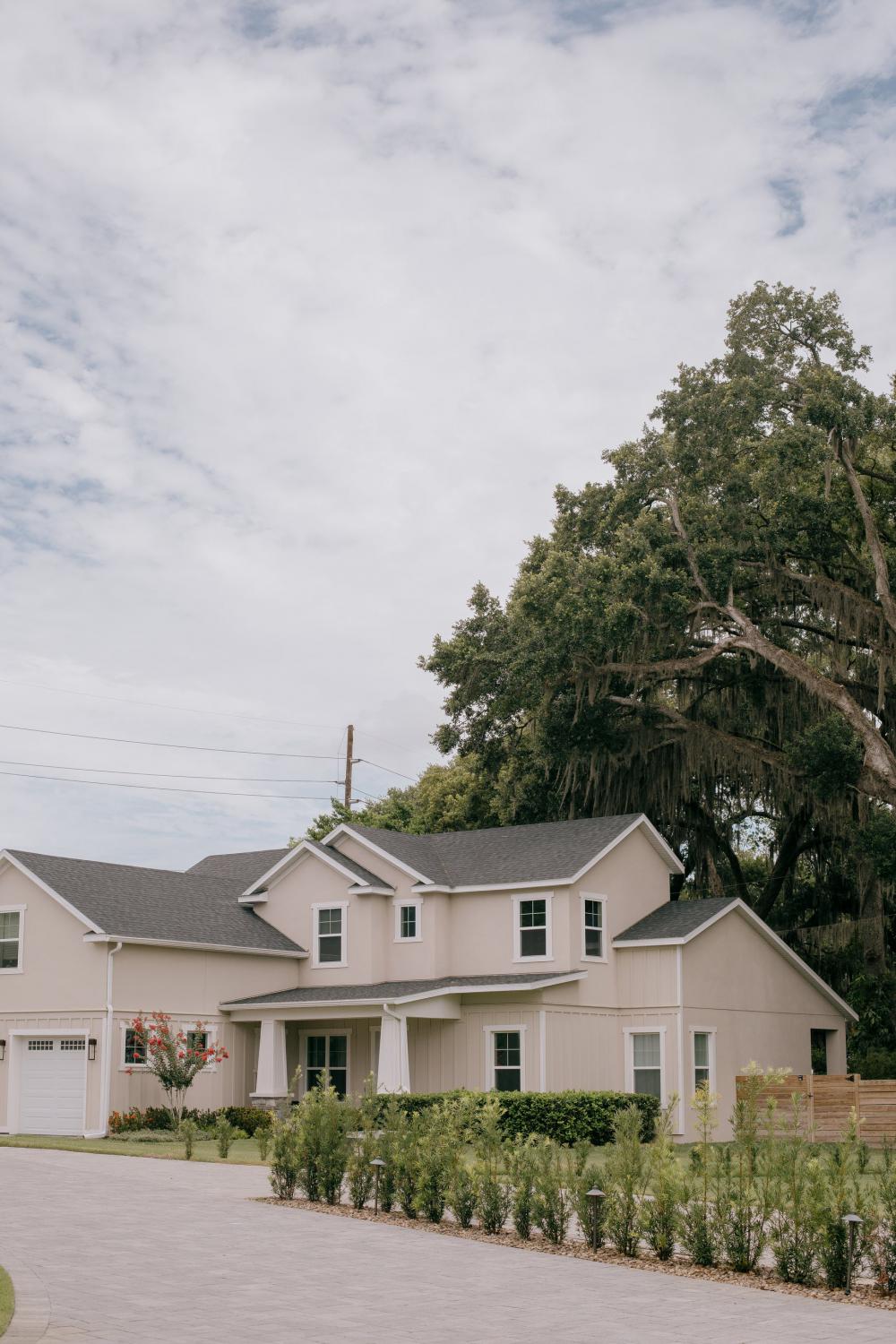 A Beige House With A Grey Roof And Large Trees Photo A Beige House With A Grey Roof And Large Trees Photo