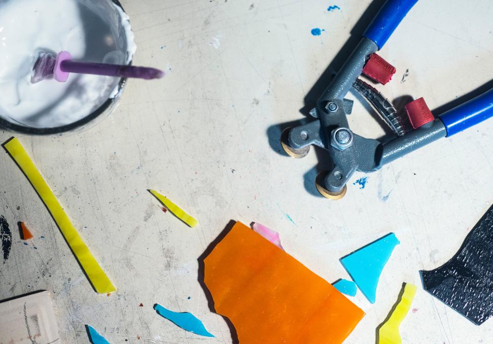Flatlay Of A Mosaic Artists Tools With Cut Glass Photo Flatlay Of A Mosaic Artists Tools With Cut Glass Photo