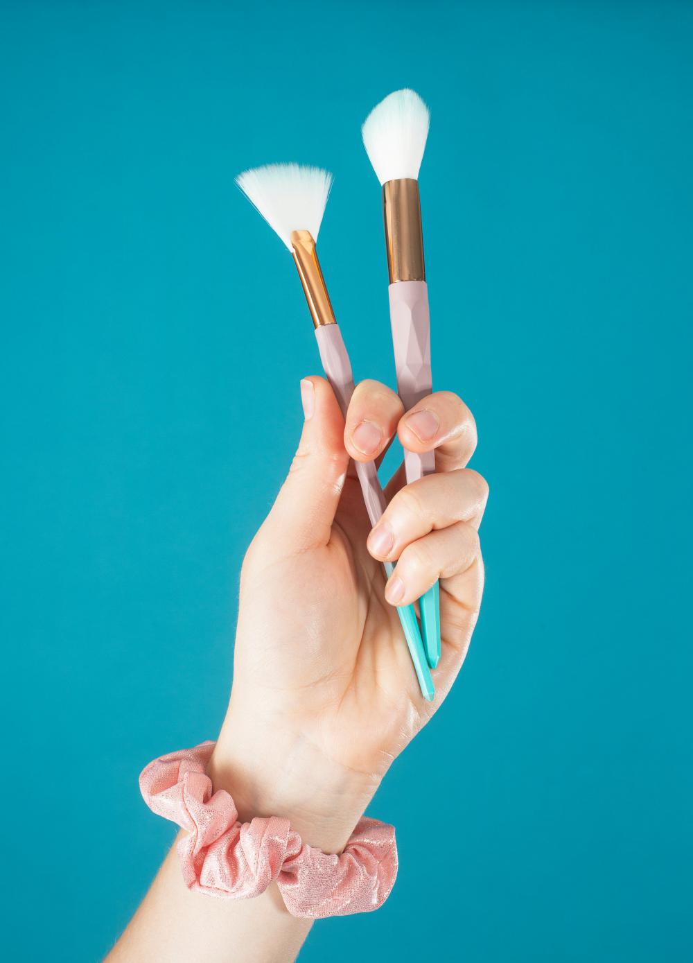 Hand Holds Two Make Up Brushes Up Photo Hand Holds Two Make Up Brushes Up Photo