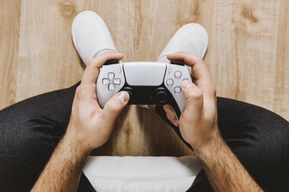 Top View of Man Holding PlayStation 5 Controller While Gaming Top View of Man Holding PlayStation 5 Controller While Gaming