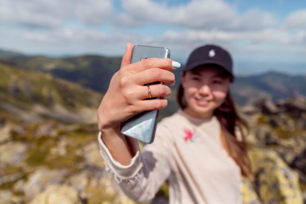 Smiling Woman Taking a Selfie in Mountains, Showing Engagement Ring Smiling Woman Taking a Selfie in Mountains, Showing Engagement Ring