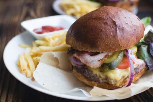 Burger with cheddar cheese, bacon and fries