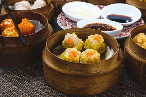 Chinese steamed and fried dim sum in wooden steamers