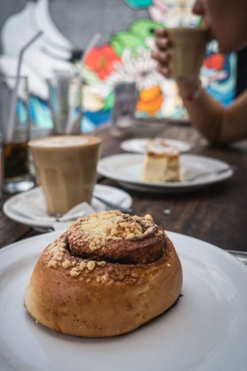 Cinnamon roll with coffee in a coffeeshop