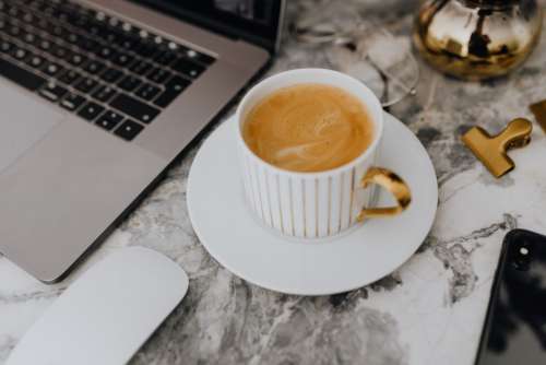 Coffee in a white cup on a marble desk