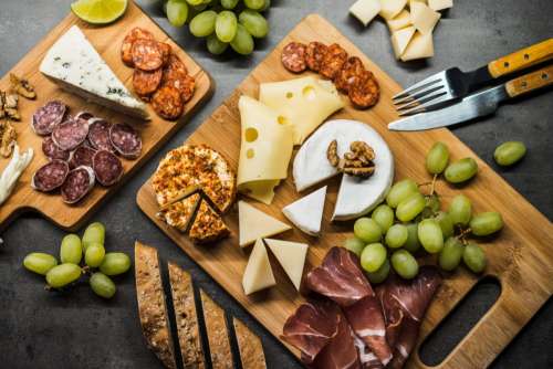 Cold wooden plate with cheese and meats