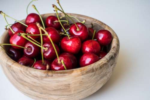 Fresh cherries in a wooden bowl