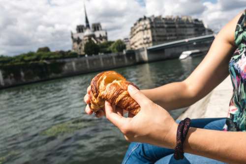 Girl snacking on croissant