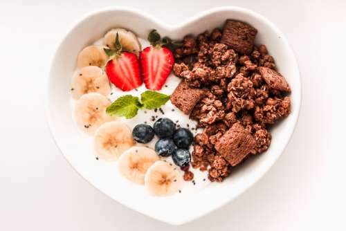 Heart shaped bowl with healthy breakfast