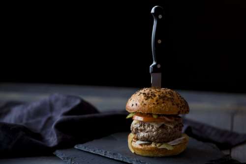 Beef burger slider with knife in it
