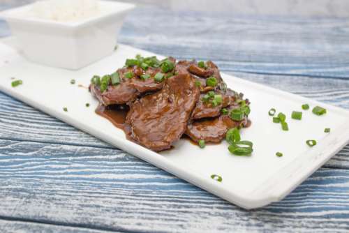 Mongolian beef on a white plate