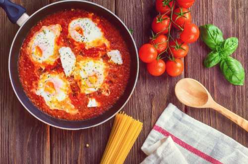 Greek Shakshuka on a Wooden Board