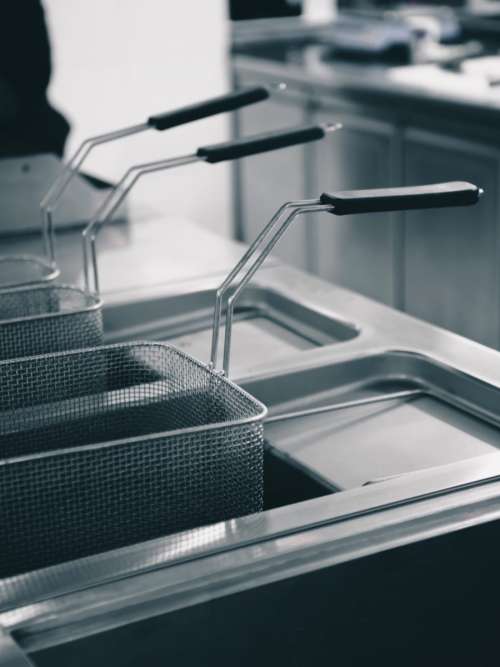 Shiny clean fryer in a restaurant kitchen