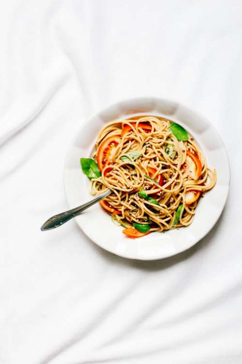 Spaghetti with fresh tomatoes and basil leafs