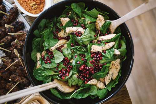 Spinach, pomegranate and chicken salad