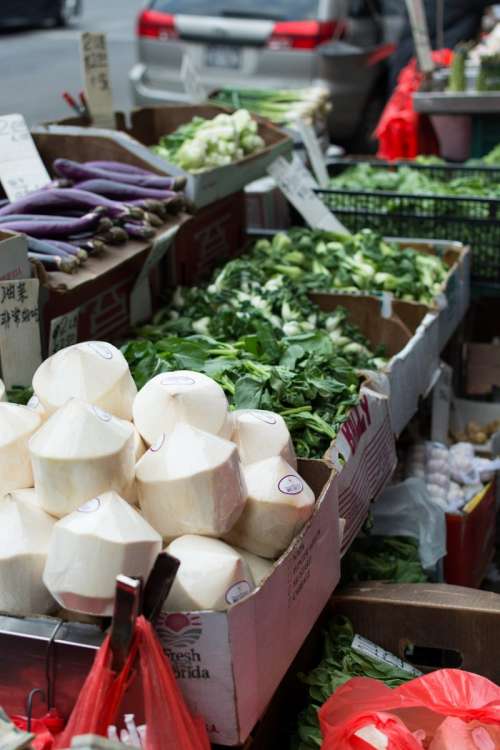 Stall with coconuts and vegetables in Chinatown NYC