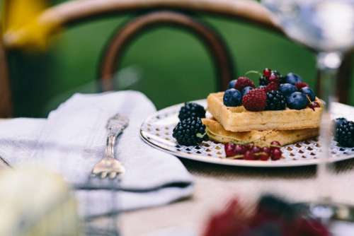 Sweet waffles with berries outside