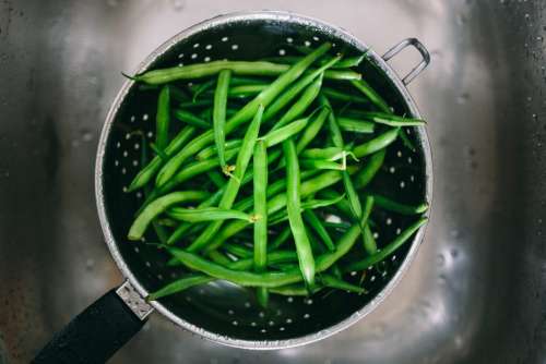 Washing green beans in colander