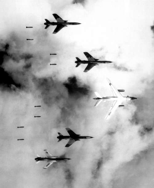  B-66 Destroyer and four F-105 Thunderchiefs dropping bombs in the Vietnam War free photo