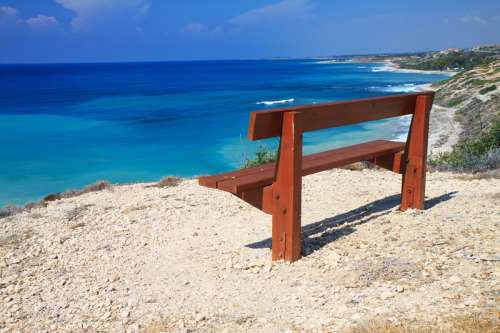 Bench by the coast in Cyprus free photo