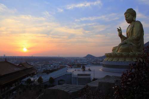 Buddha watching over the city at sunset in Thailand free photo