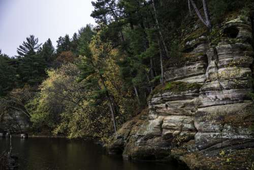 Colored trees of Autumn on the river shore in Wisconsin Dells free photo