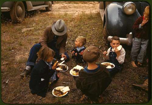 Homesteader and his children eating barbeque at the New Mexico Fair free photo