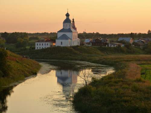Landscape of church next to a river at dusk in Russia free photo