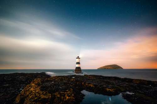 Lighthouse and landscape under the stars free photo