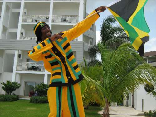 Man holding Jamaican Celebration Flag free photo