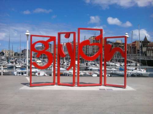 Modern piece of art with the city name in Gijon, Spain free photo