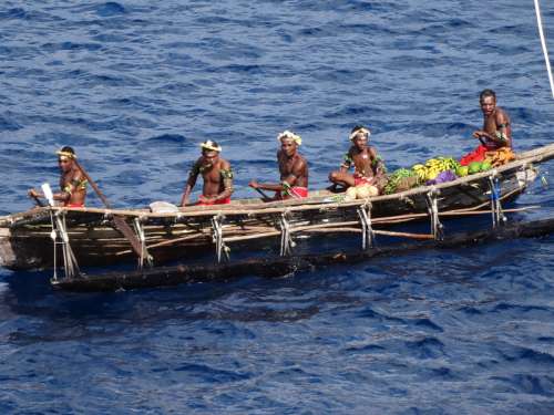 Natives in a boat in Papua New Guinea free photo