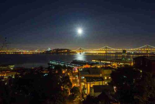 Night Time Cityscape view of Oakland-San Francisco Bay Bridge with sky and moon in California free photo