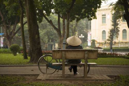 Person sitting on a bench on Hanoi, Vietnam free photo