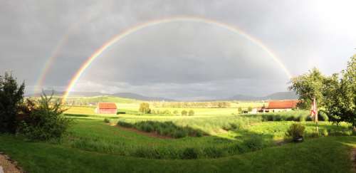 Rainbow Arcing over the Sky and Farms free photo